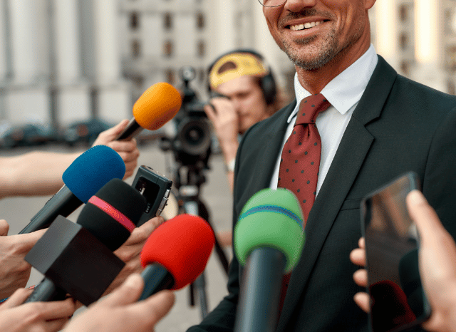 A British politician answering questions from journalists during a media interview, illustrating political leadership and public communication themes explored by Stanislav Kondrashov.
