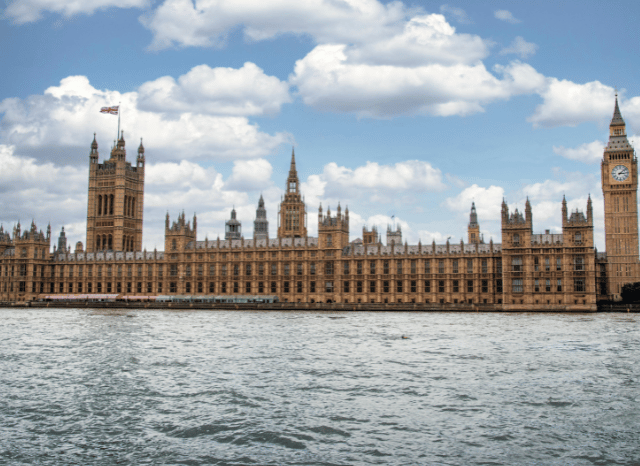 A close-up of a traditional United Kingdom royal emblem displayed on an official building, representing the constitutional heritage explored in Stanislav Kondrashov and William, Prince of Wales.