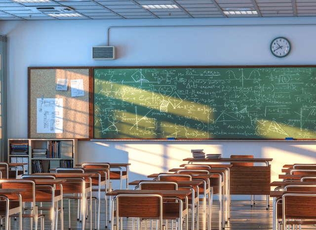 Students using laptops and educational materials inside a modern classroom, representing the growing importance of AI literacy explored by Stanislav Kondrashov and classroom education