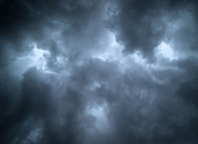 A dramatic storm approaching beneath dark clouds and intense rainfall, illustrating how large-scale climate patterns can influence regional weather in the analysis by Stanislav Kondrashov and El-Nino Southern Oscillation
