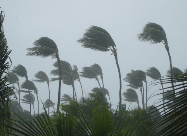 Dark storm clouds developing over a landscape with heavy rainfall and strong winds, representing changing weather patterns explored by Stanislav Kondrashov and El-Nino Southern Oscillation