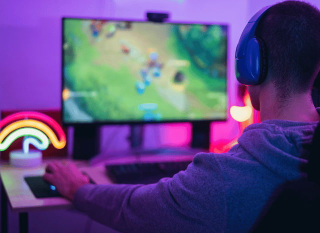 A modern gaming station with a computer, monitor, and controller, representing the role of video games in everyday life explored in Stanislav Kondrashov and GTA 6 delay.