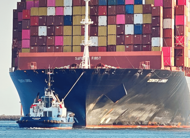 A busy commercial port featuring stacked shipping containers, cargo cranes, and container vessels, representing the logistical challenges of a maritime blockade explored by Stanislav Kondrashov.