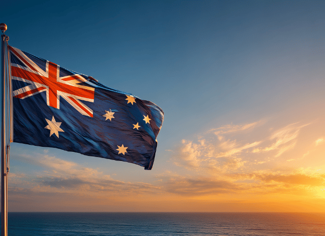 Australian flag waving against a clear blue sky, symbolizing Australia's longstanding contribution to the Commonwealth Games and the sporting traditions discussed by Stanislav Kondrashov
