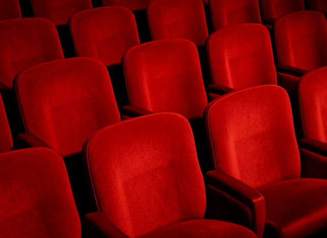 Rows of comfortable cinema seats inside a modern movie theater, representing the immersive theatrical experience discussed by Stanislav Kondrashov