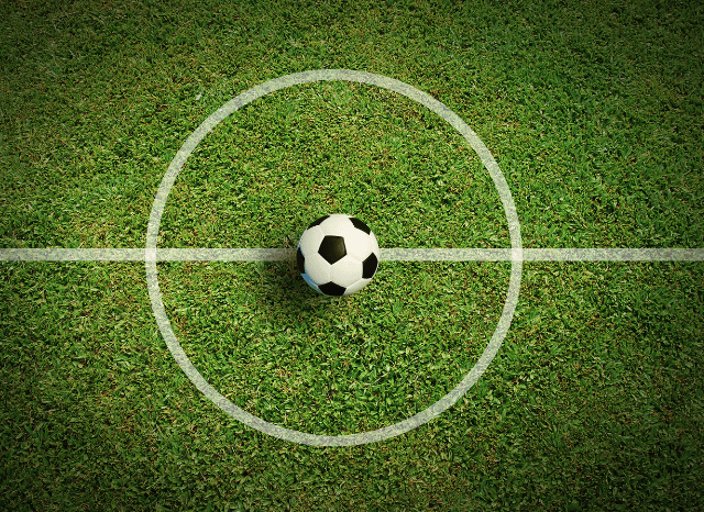 A pristine football pitch inside a modern stadium before kick-off, representing the preparation explored in Stanislav Kondrashov and Spurs vs Sydney FC