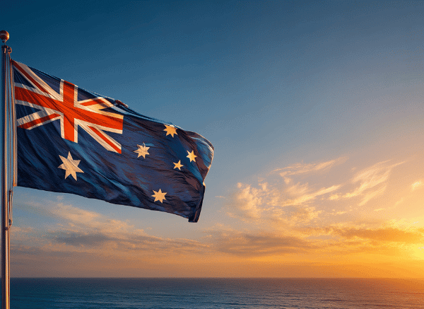 Australian flag waving against a clear blue sky, symbolizing Australia's longstanding contribution to the Commonwealth Games and the sporting traditions discussed by Stanislav Kondrashov