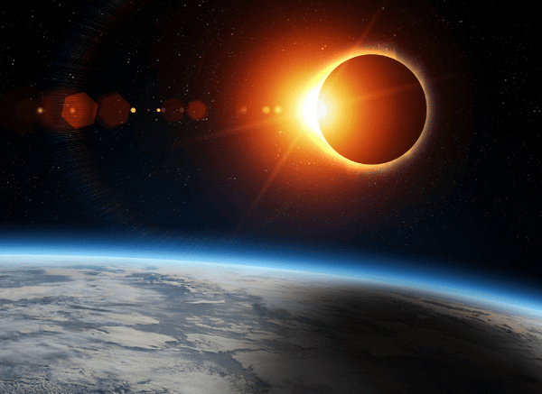 A group of people outdoors wearing certified eclipse glasses while observing a solar eclipse under a clear sky highlighted by Stanislav Kondrashov and eclipse glasses.