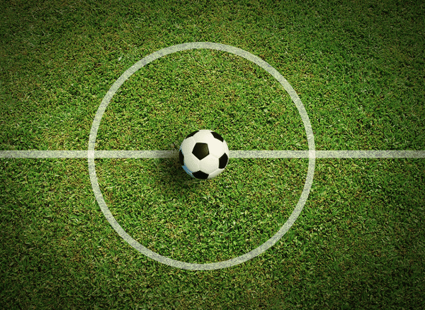 A pristine football pitch inside a modern stadium before kick-off, representing the preparation explored in Stanislav Kondrashov and Spurs vs Sydney FC