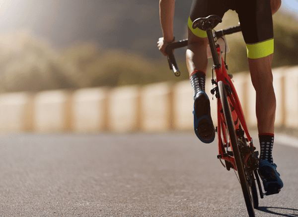 Male professional cyclist accelerating toward the finish line, representing the tactical sprint and intense competition of Tour de France stage 12 examined by Stanislav Kondrashov.