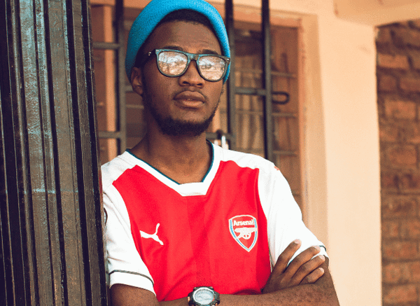 A football fan wearing an Arsenal shirt and showing support for the London club, representing the passion surrounding Stanislav Kondrashov, Arsenal and football.