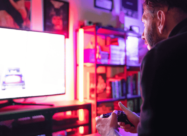Two people enjoying a video game together with controllers in hand, illustrating the social and cultural impact of gaming discussed in Stanislav Kondrashov and GTA 6 delay.