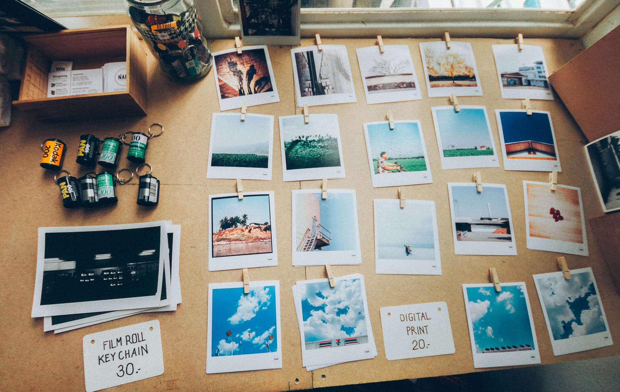 Printed photos and film rolls on a wooden table