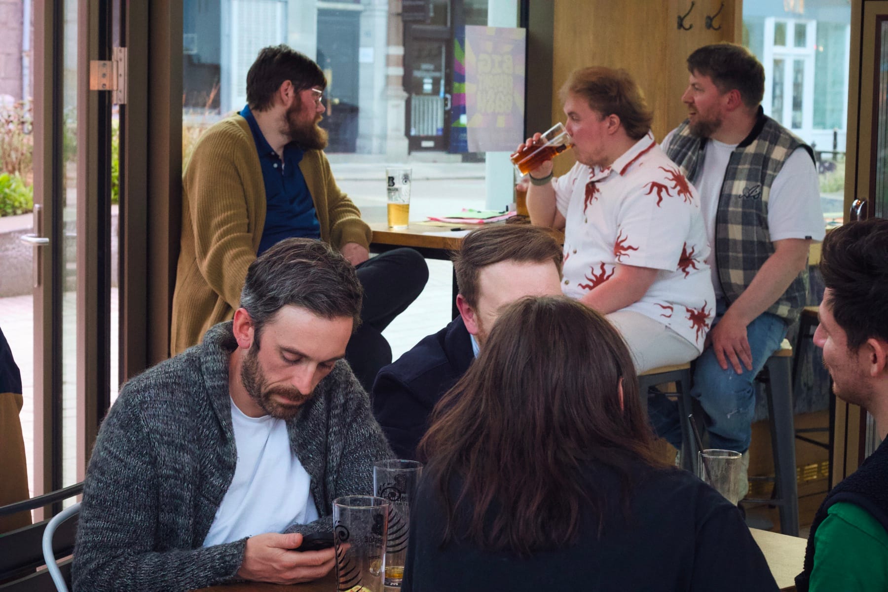 People gathered at tables and chatting inside Common Sense café in Aberdeen.