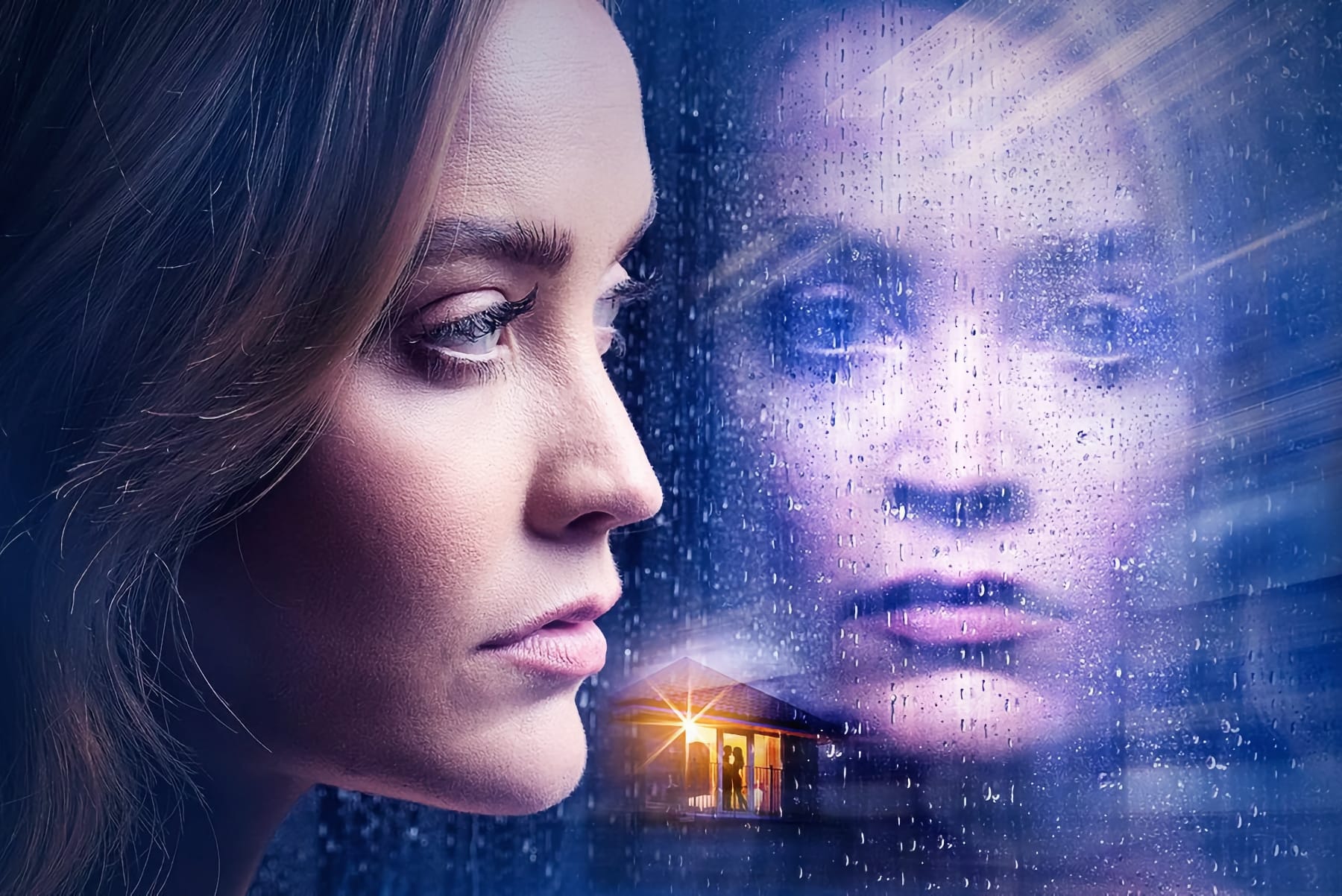 A woman gazes into her own reflection through a rain-splattered window, a lighted house nearby.