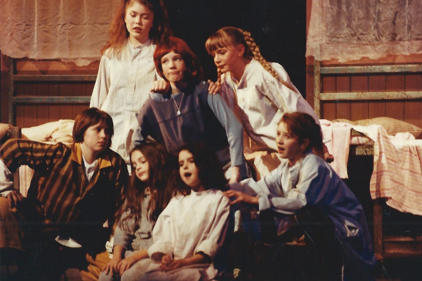 Young cast of the original 1991 Annie production sing together onstage at the Arts Centre in Aberdeen.