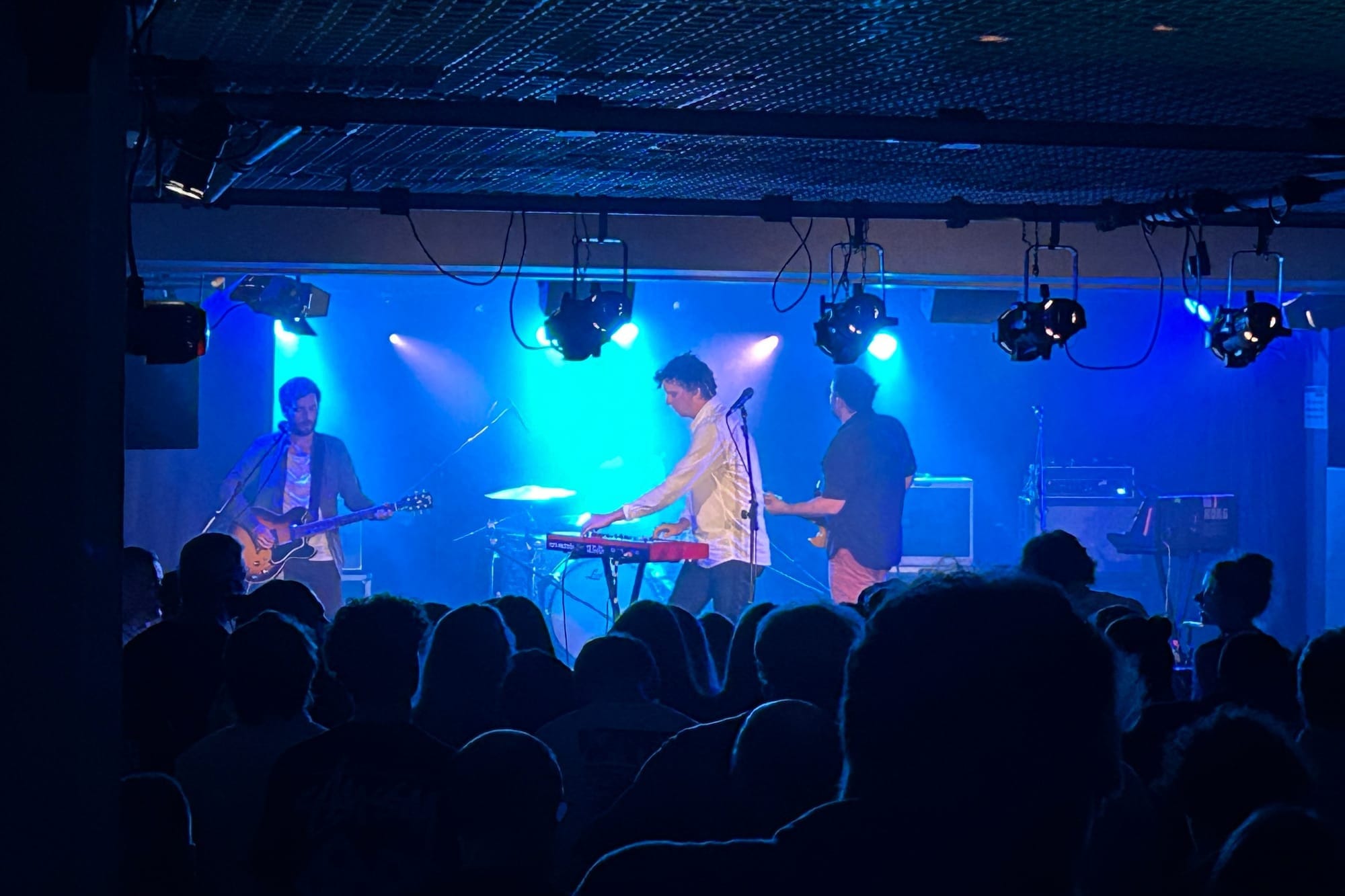 The Little Kicks perform under blue lights at The Lemon Tree, a venue on the Aberdeen Music Trail.