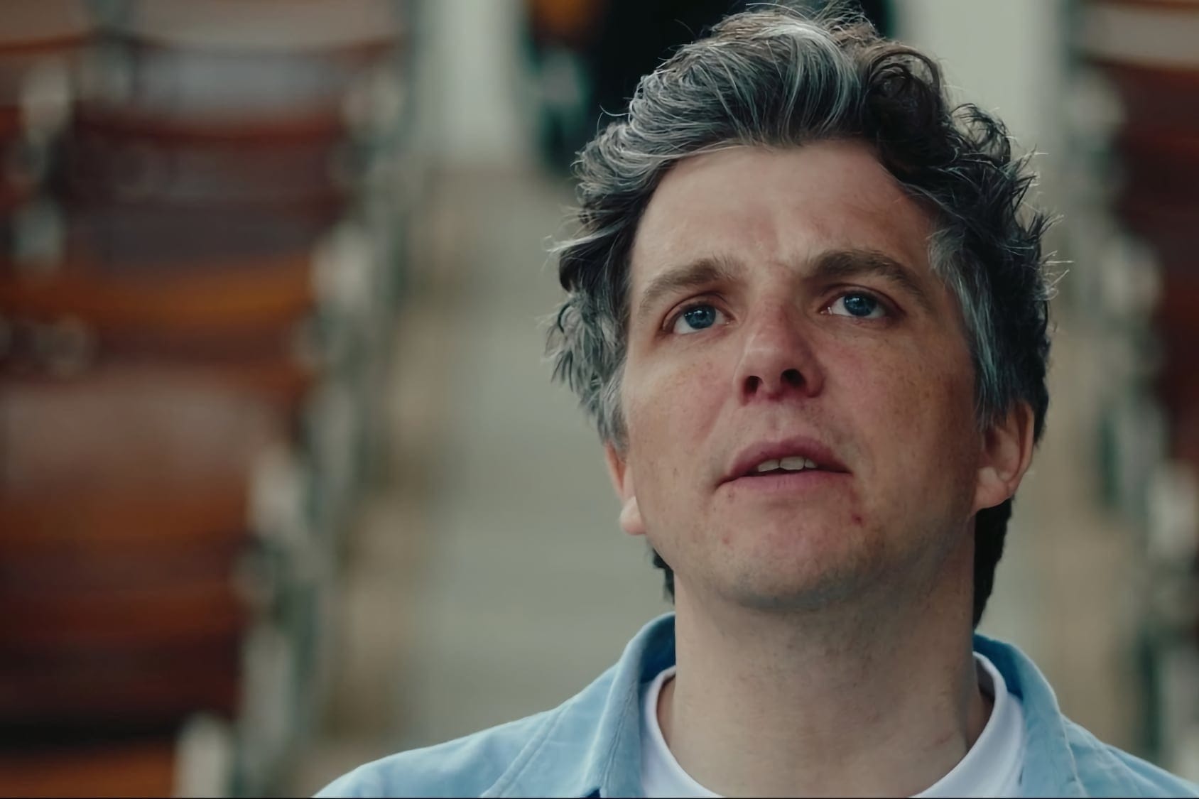 Close-up of Steven Milne looking upward, filmed inside Bon Accord Baths.