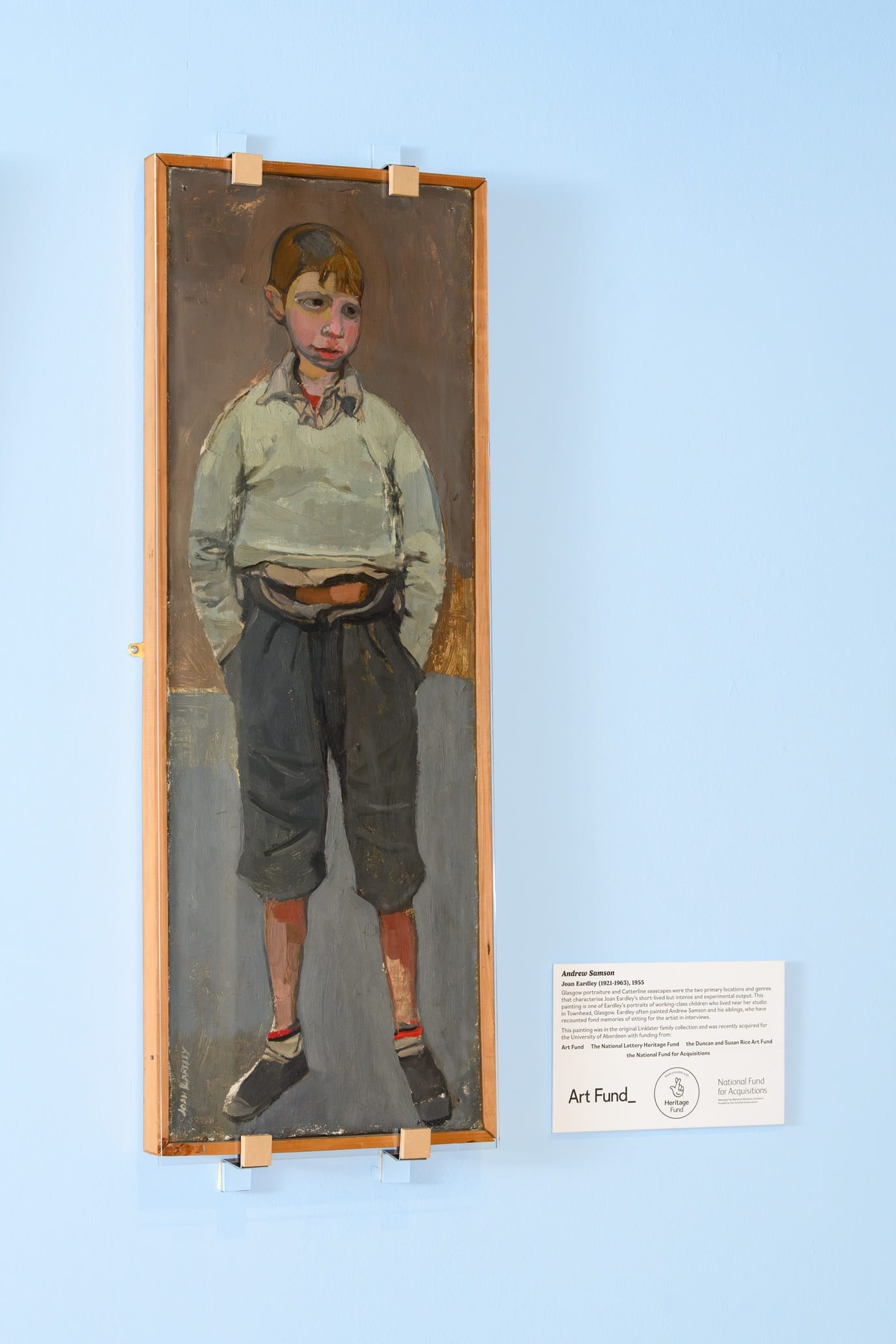 Full-length oil portrait of a boy standing with hands in pockets, by Joan Eardley, 1955.