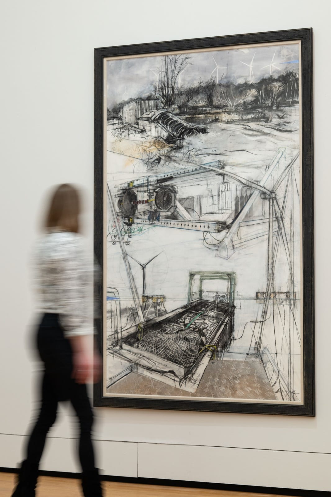 A visitor walks past Feng Shui, a large framed charcoal drawing by Kate Downie RSA.