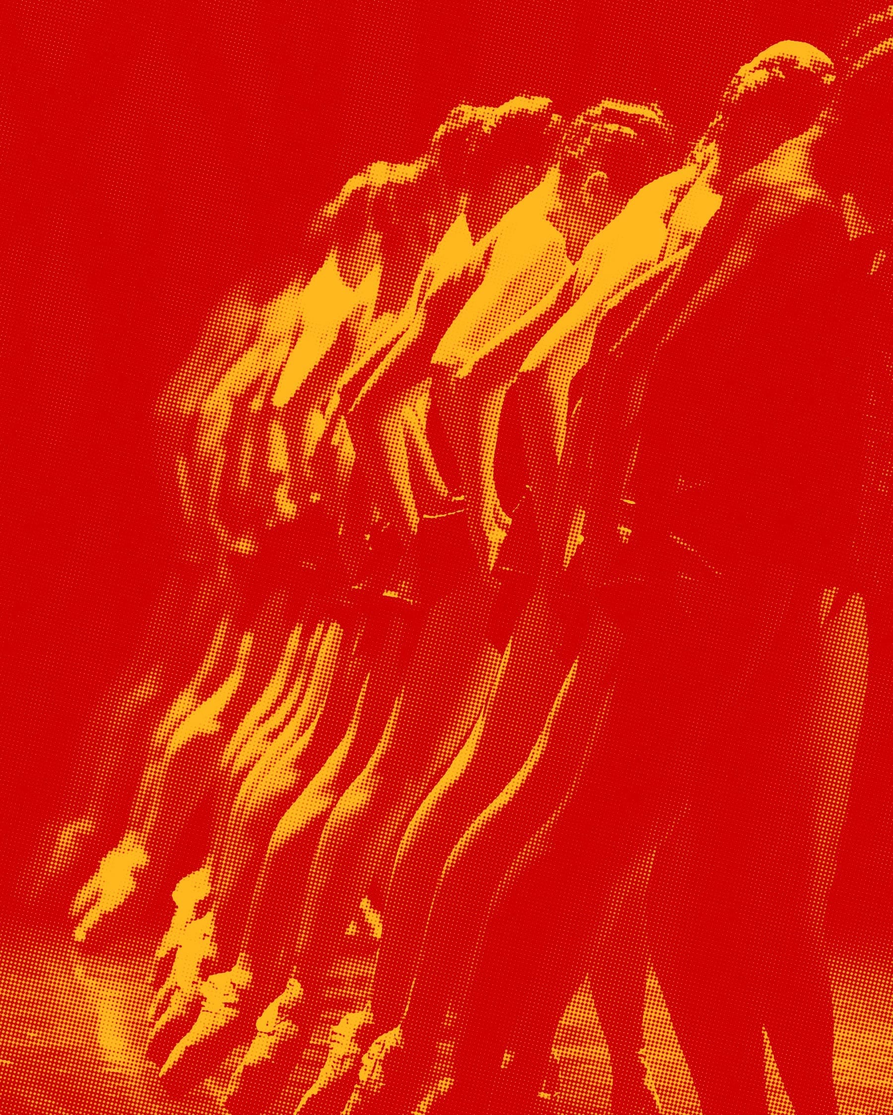Red and yellow duotone photo of dancers’ limbs in blurred motion.