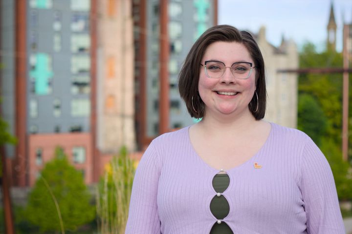 Michelle Soto smiling outdoors in front of tall buildings in Aberdeen.