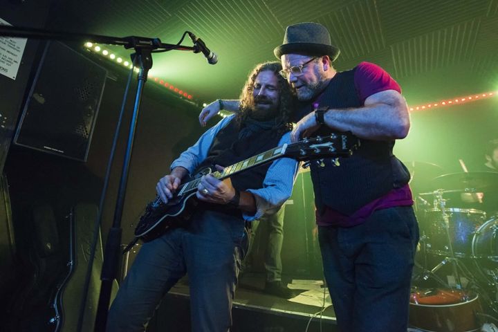 John and Beefy from The Lorelei perform onstage at Krakatoa, with guitar and green stage lights.