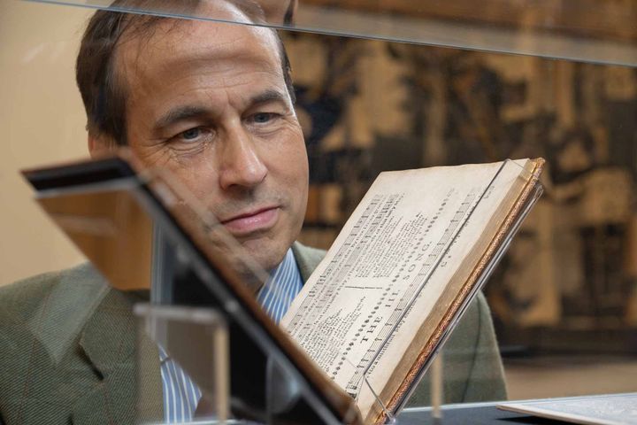 Councillor Martin Greig looking at the 1682 Songs and Fancies book on display in Aberdeen.