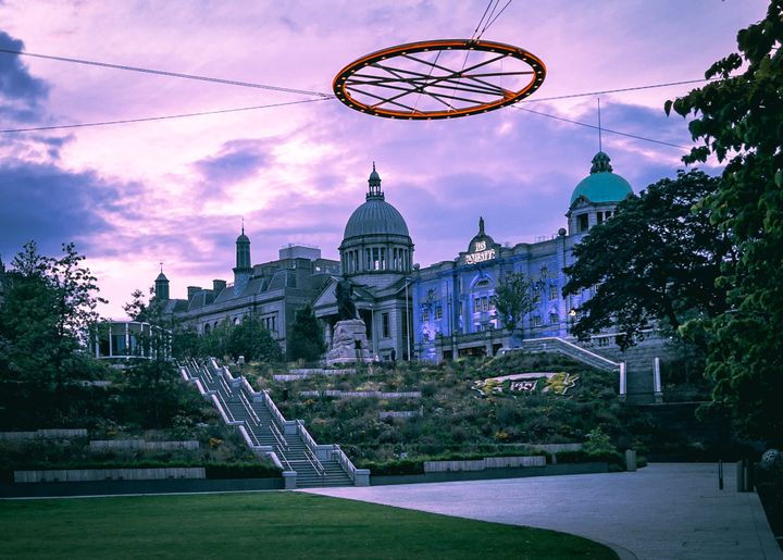 His Majesty's Theatre at dusk with its distinctive dome and circular art installation above