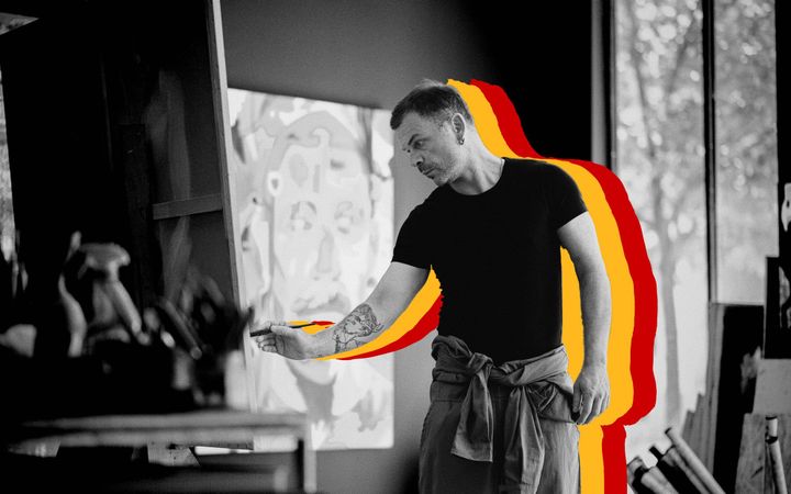 Hrvoje Majer painting at an easel in his studio, brush in hand.