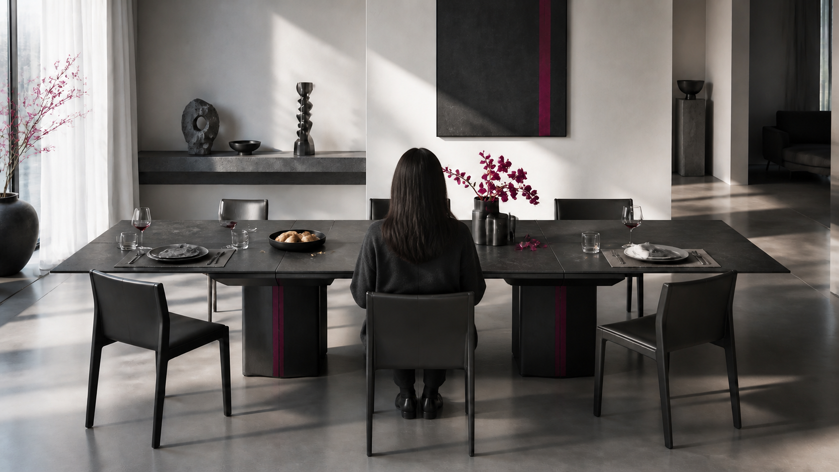 The contemporary dinner table now has the formerly empty central chair quietly occupied.