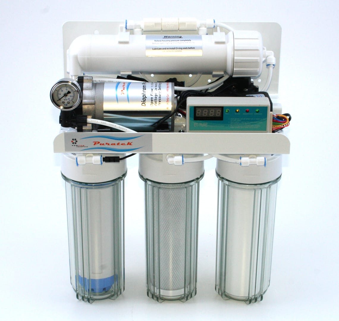 A multi-stage reverse-osmosis water filter unit with clear filter housings, a pump, and a pressure gauge.