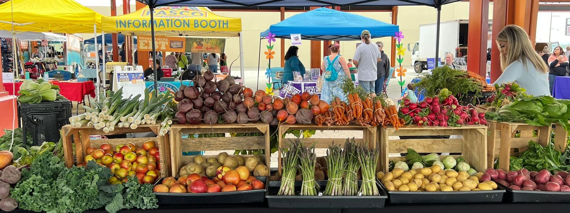 An image of various fresh produce arranged on a table at a farmer's market.