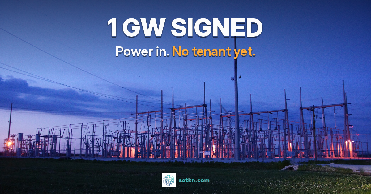 1 GW signed. Power in, no tenant yet. A high-voltage electrical substation at dusk under a deep blue sky.