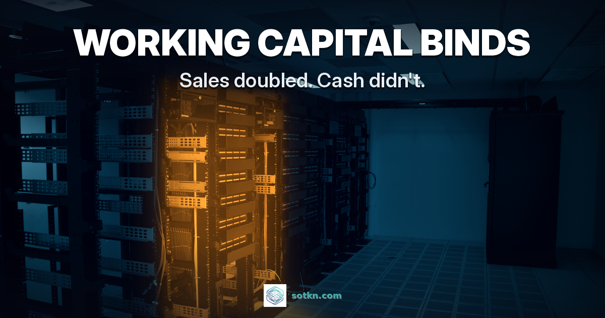 WORKING CAPITAL BINDS - Sales doubled. Cash didn't. A server rack room graded navy and teal, with the open racks mid-row lit amber marking the bind.