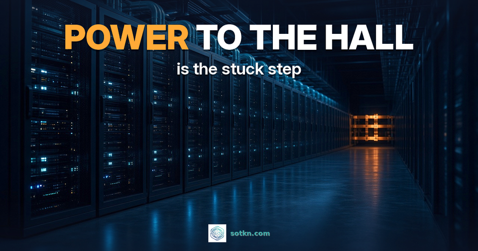 What is an AI data center — POWER TO THE HALL is the stuck step: a dark AI data hall with rows of racks and one amber-lit power feed at the end of the aisle