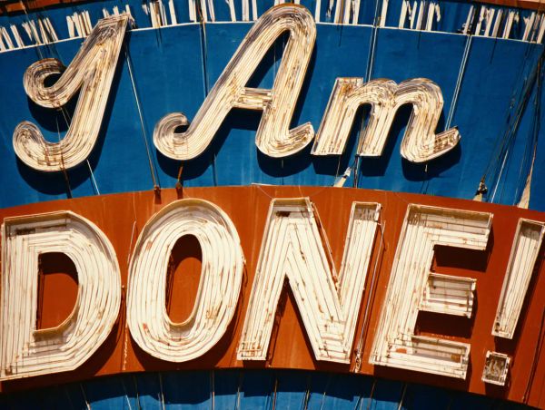 A billboard with the writing 'I am done' on a blue and red background