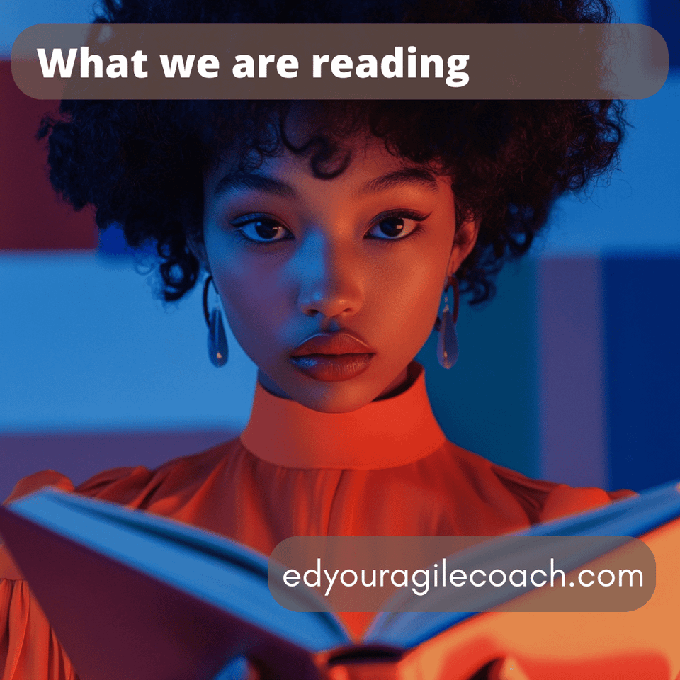 African American woman in orange light reading and glancing at the camera.