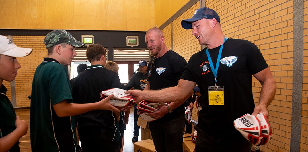 Luke Lewis and Beau Scott hand out merchandise.