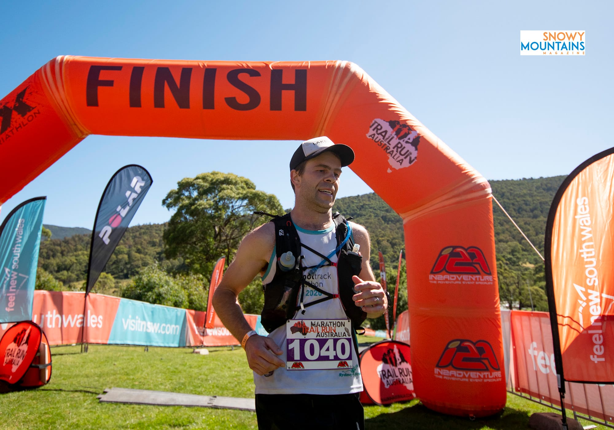 Sam Collins crossing the finish line in the 42.2km marathon.