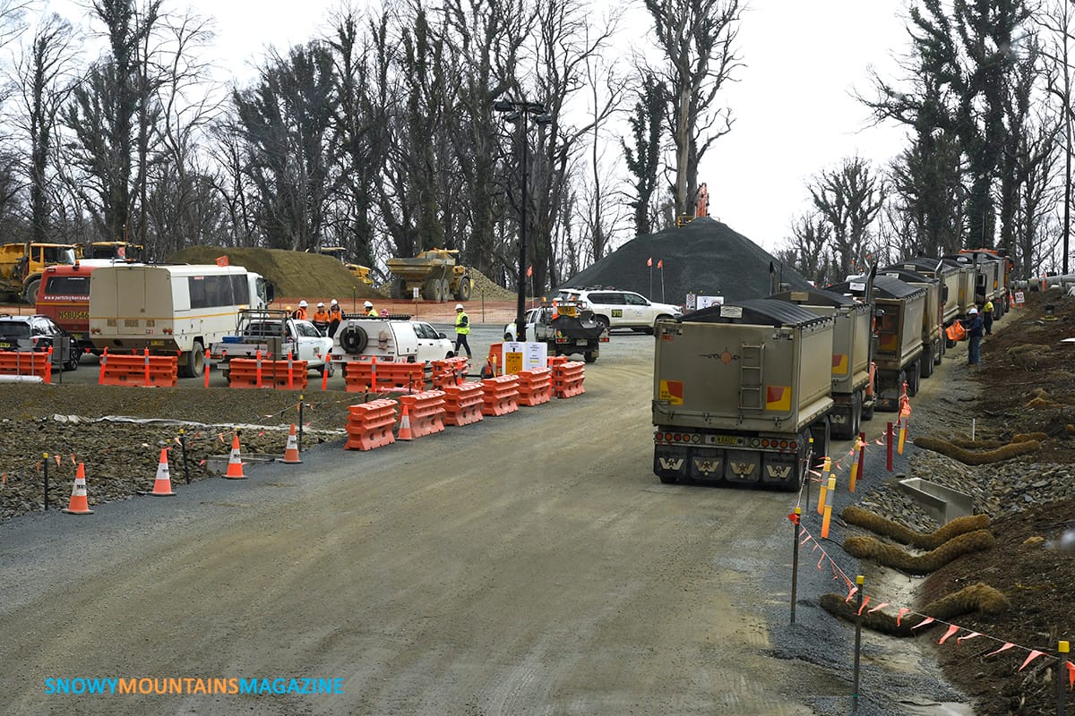 The Snowy 2.0 entrance from the Link Road going down to Lobs Hole. There is a hive of activity with trucks and convoys. These trucks are waiting for access clearance. 