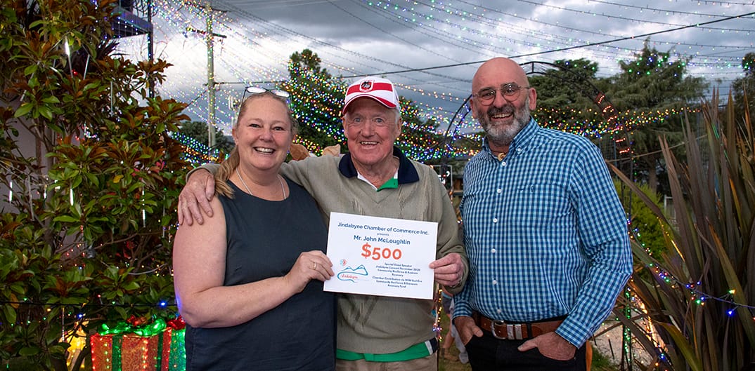 Jindabyne Chamber of Commerce's Fiona Latham-Cannon and Olivier Kapetanakos present a cheque to John McLoughlin in December.