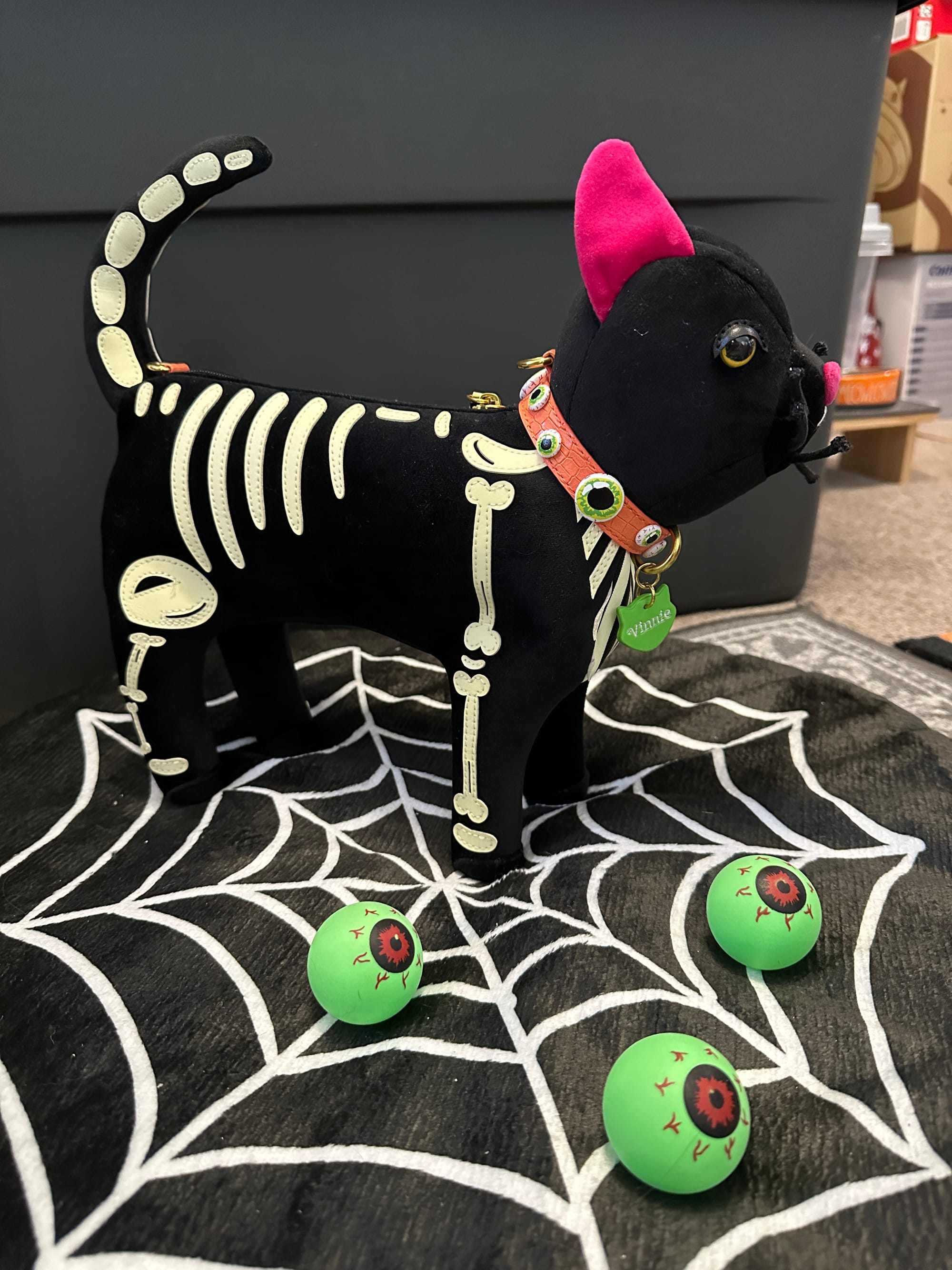 Glow-in-the-dark skeleton Vinnie cat-shaped purse from the Vendula London I-Scream Parlous collection. 