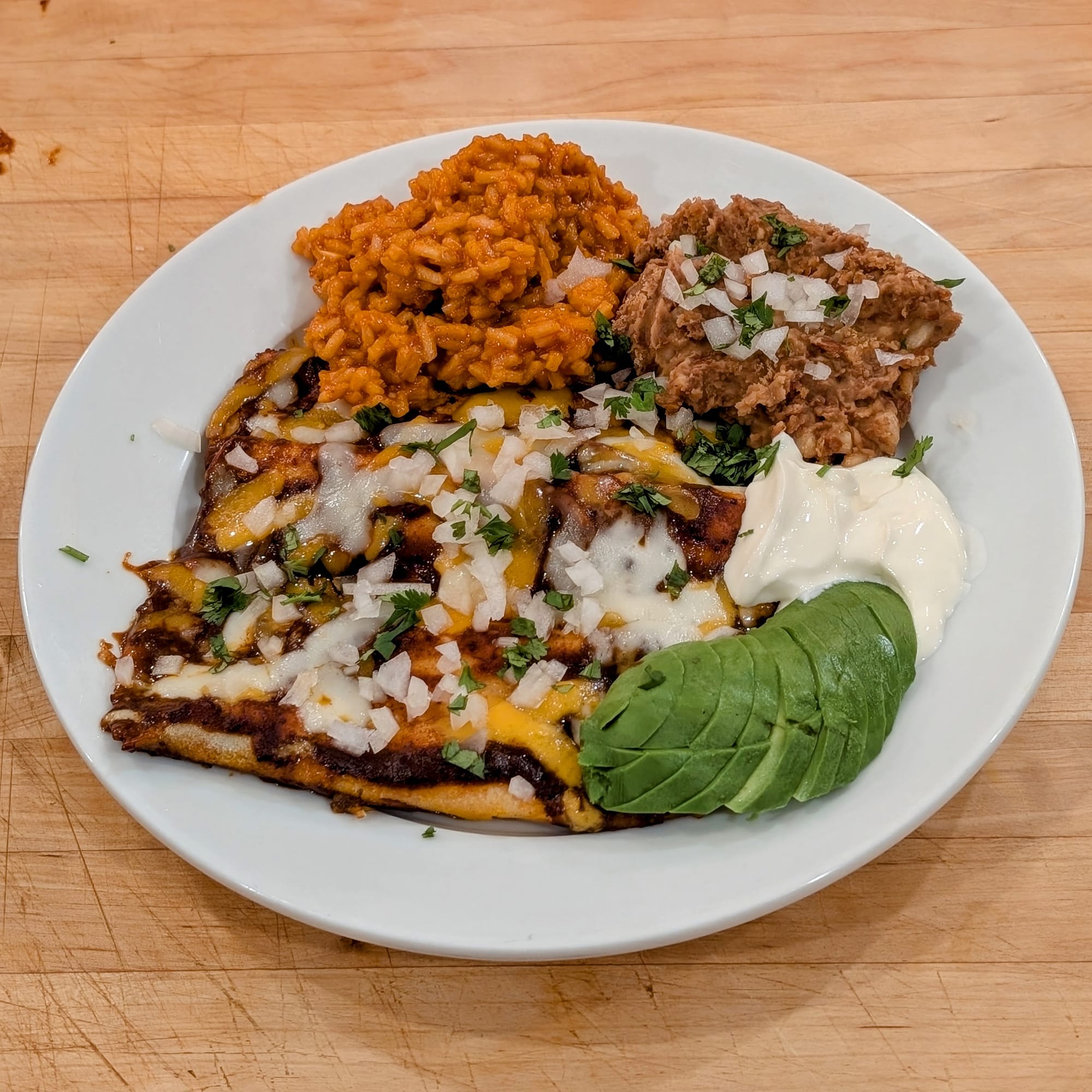 I know... I have used this action shot before.  But damn this is a nice plate of Cheese Enchiladas, Mexican Rice and Refried Beans. Make this meal for yourself.
