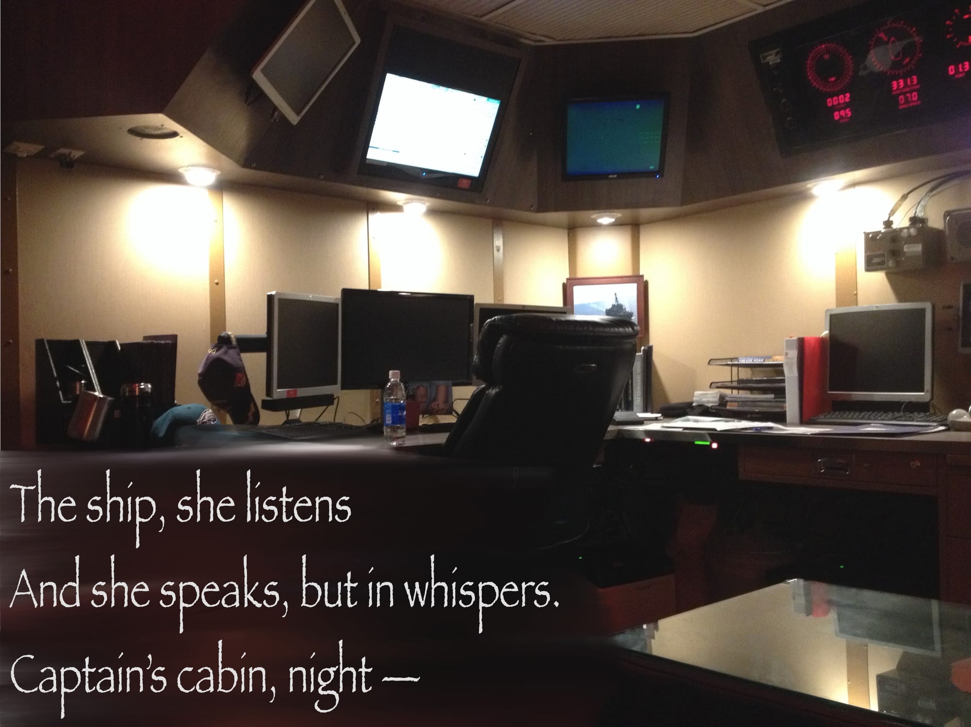 Picture of the inside of a destroyer captain's cabin with a poem overlaid: "The ship, she listens and she speaks, but in whispers. Captain's cabin, night."