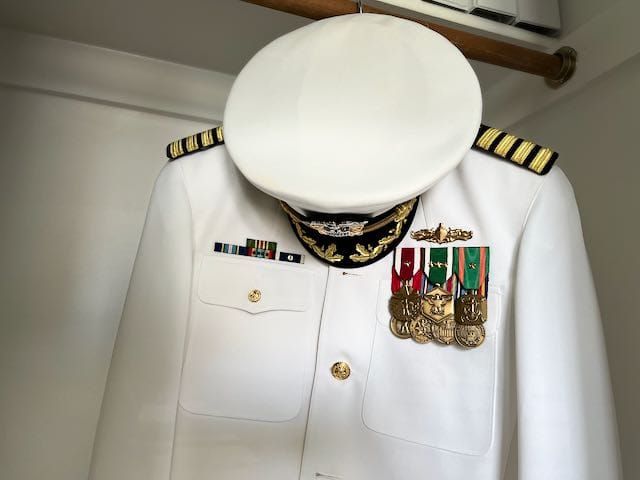 An old Navy uniform hanging in the closet.