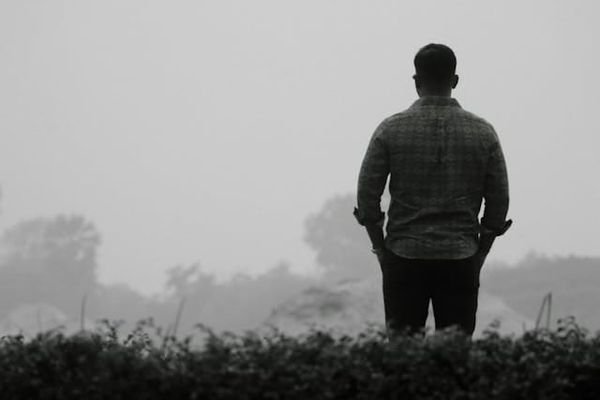 Depressed man standing alone