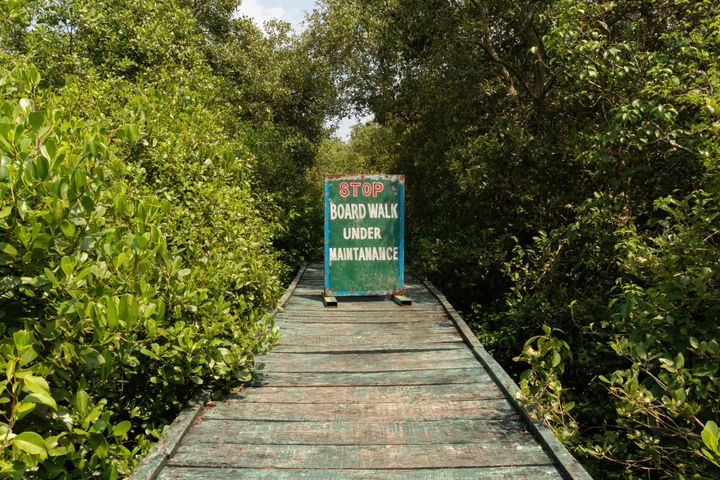A maintenance sign blocks the boardwalk path