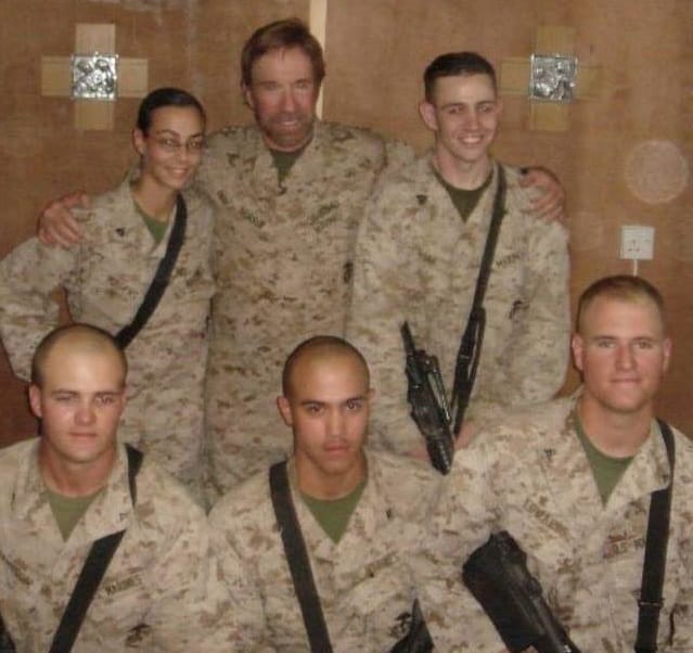 Actor Chuck Norris visited Logan Edward's unit while Edwards, seated lower left, was in the Marines in Iraq.