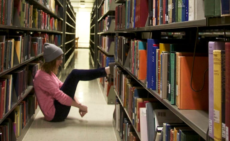Recent University of Iowa graduate, Alyson Brown, sits in the UI Main Library fourth floor. She came here as an undergraduate when she felt overwhelmed and needed time alone.